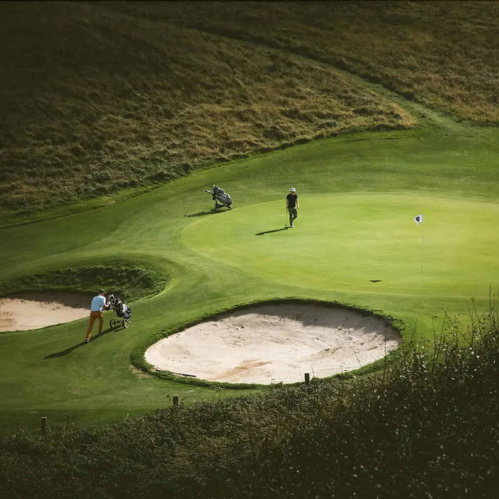 Golfers on a green using SolRX golf sunscreen; 8-hour protection that doesn't affect grip or sting eyes
