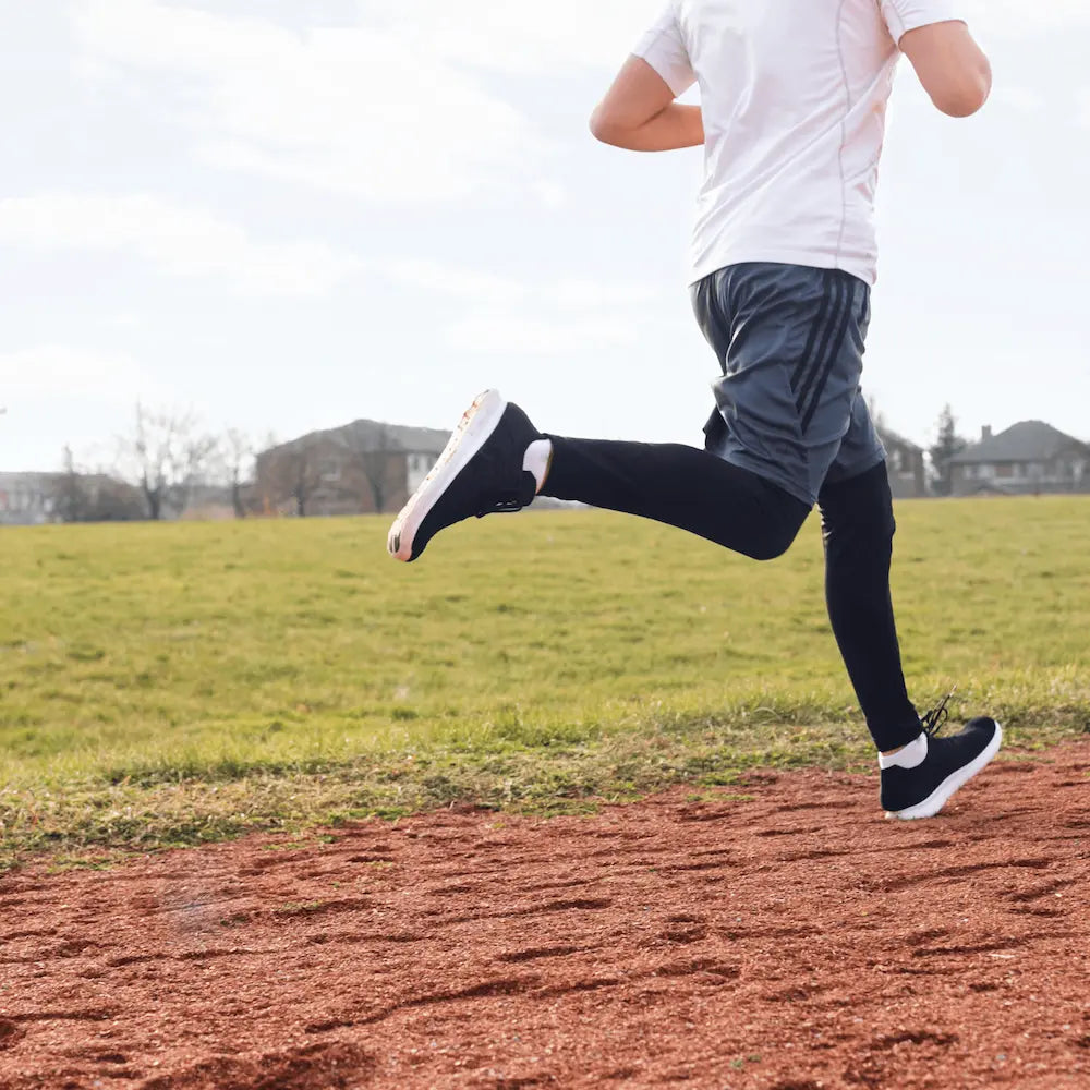 Athlete running outdoors using SolRX sport sunscreen; sweat-proof protection that won't run into eyes