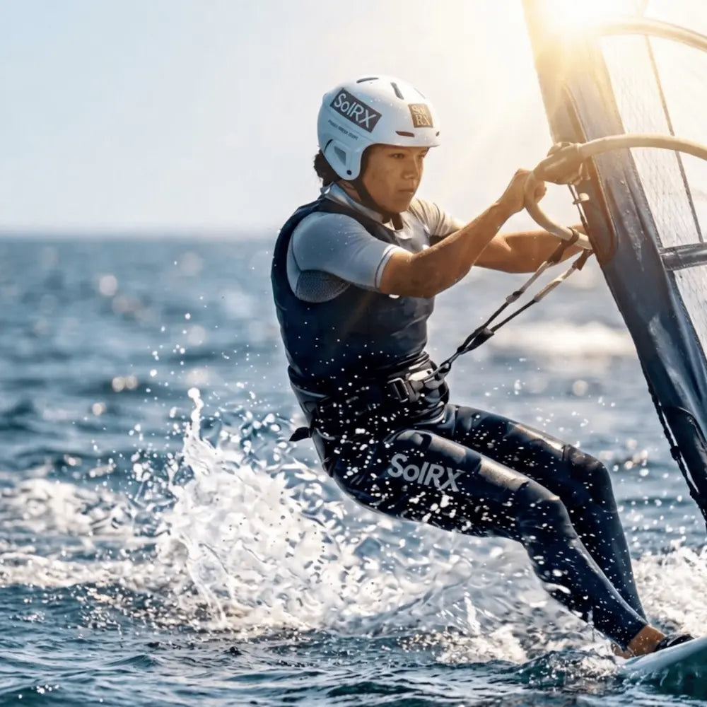 Athlete windsurfing using SolRX Waterblock sunscreen for high-performance water resistance