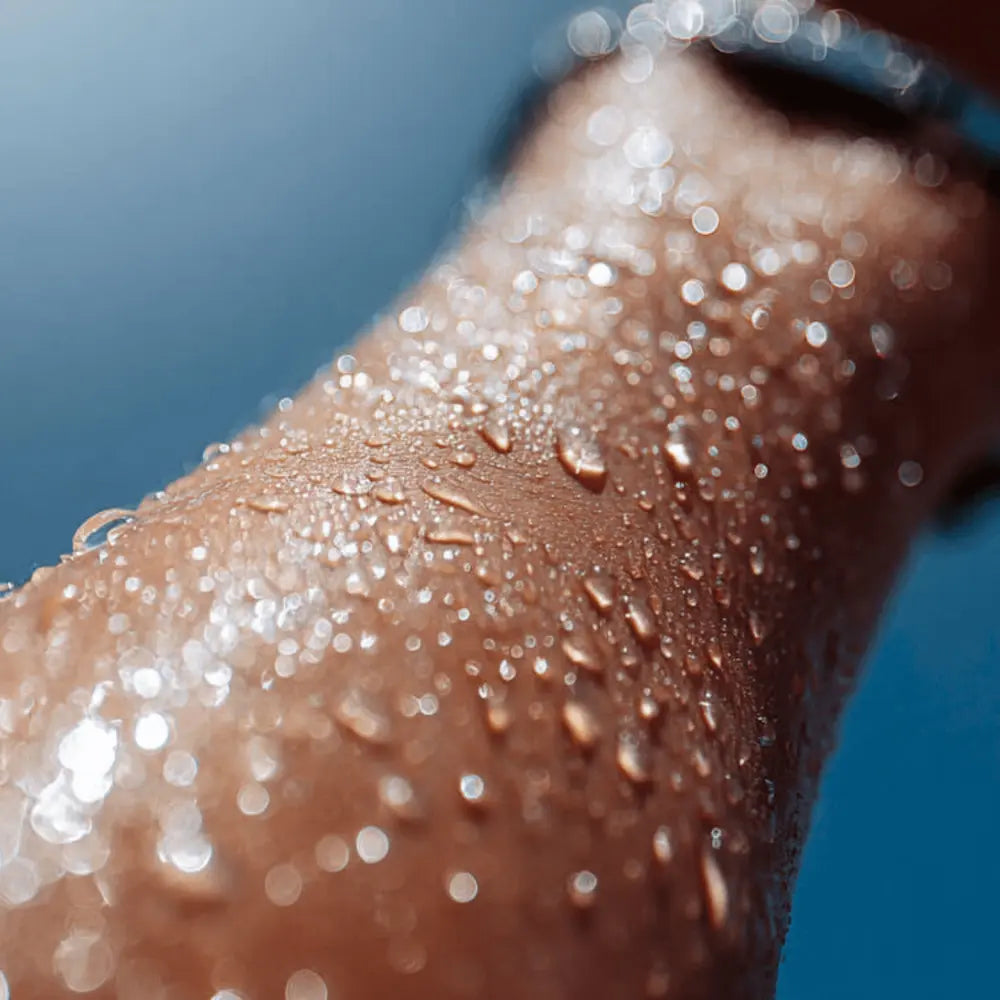 Close-up of water beading on skin to demonstrate SolRX Waterblock 8-hour water-resistant technology